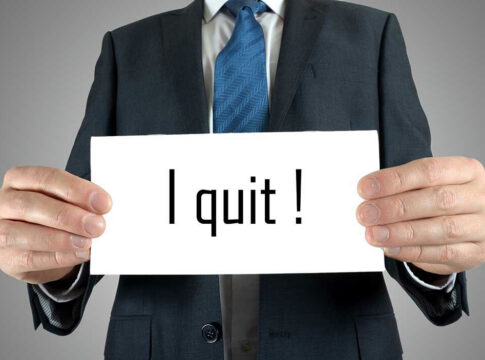 Person holding a sign that says I quit!.