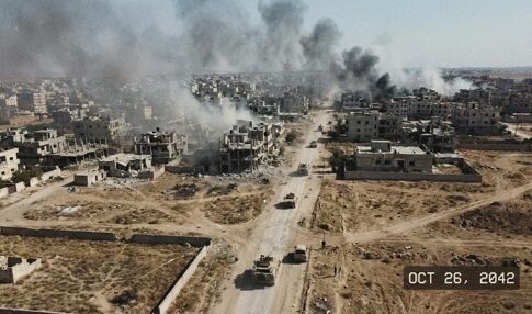 Aerial view of a war-torn city with smoke rising from buildings